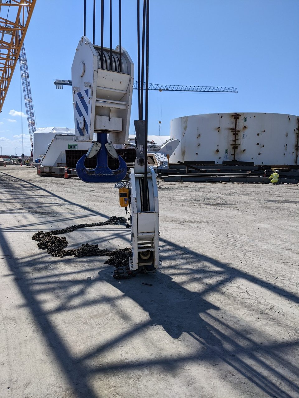 HoistCam camera on a crane hook block above a construction work yard